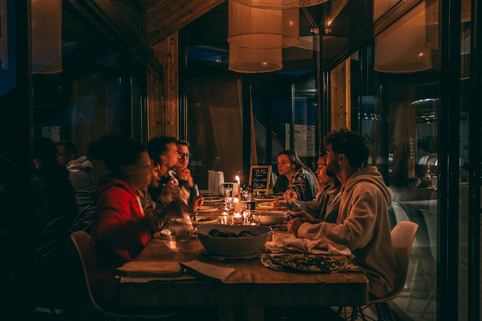 People enjoying a candlelit dinner at a dimly lit restaurant
